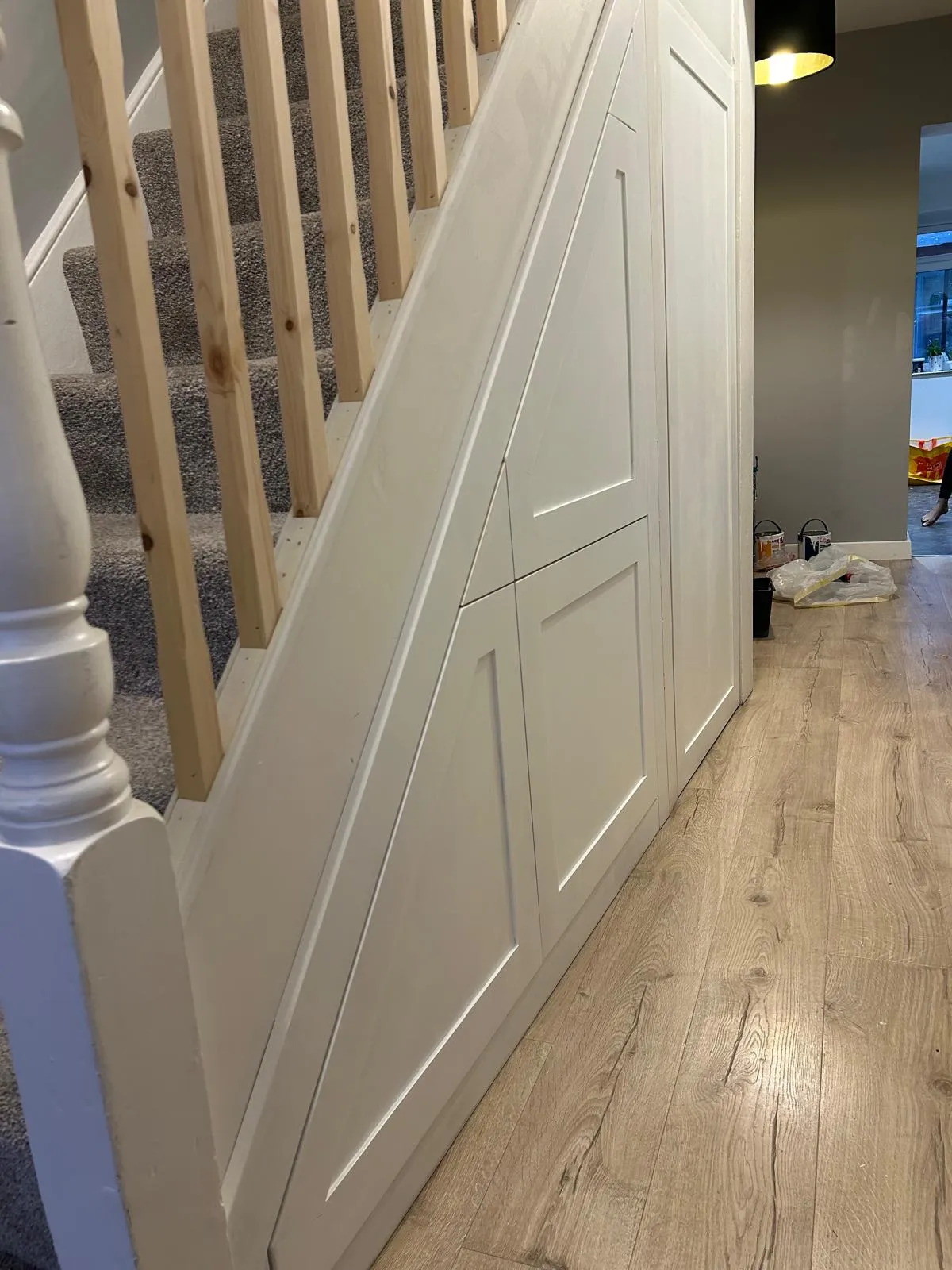 Painted shaker doors fitted under a staircase